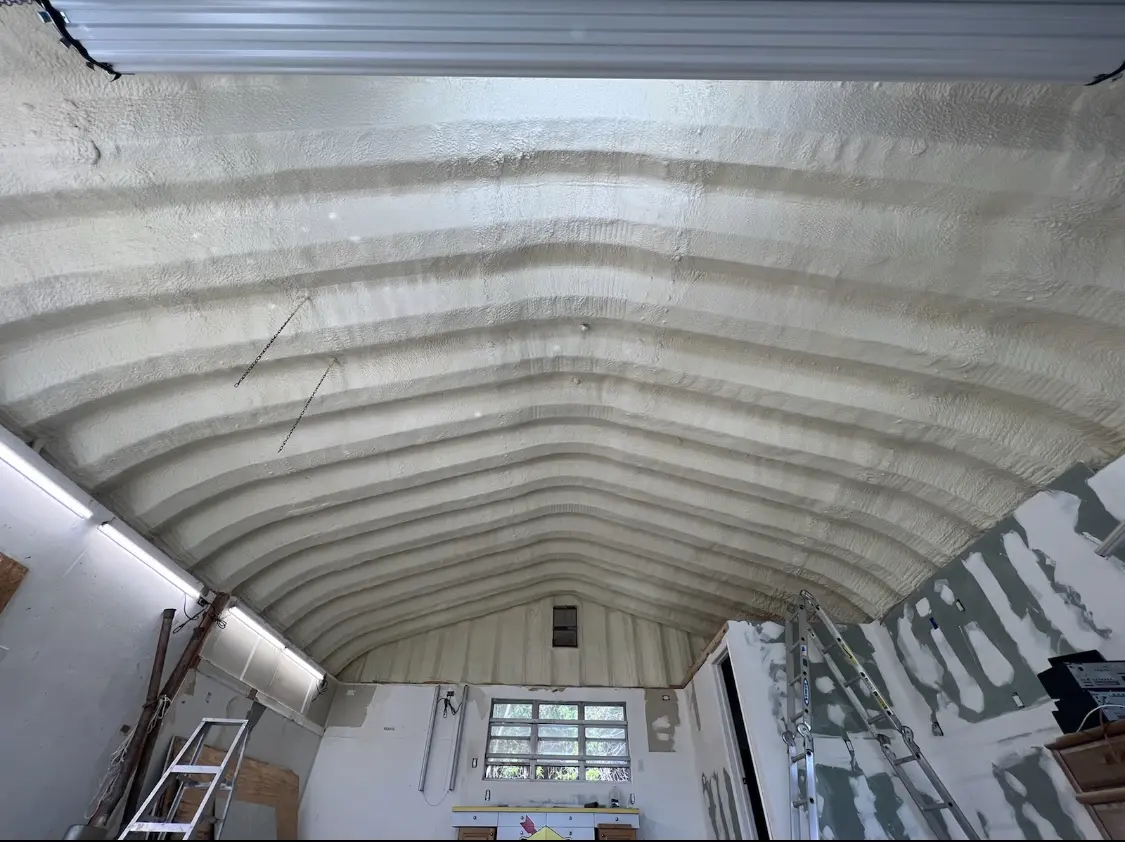 Spray polyurethane foam applied to the underside of a metal roof deck in Texas City